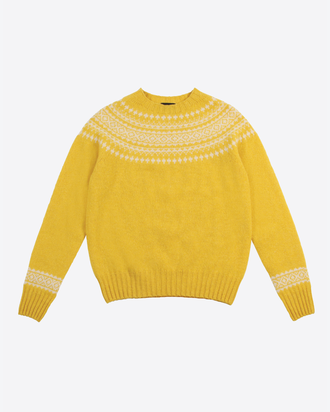 Yellow sweater with white pattern on a light gray background