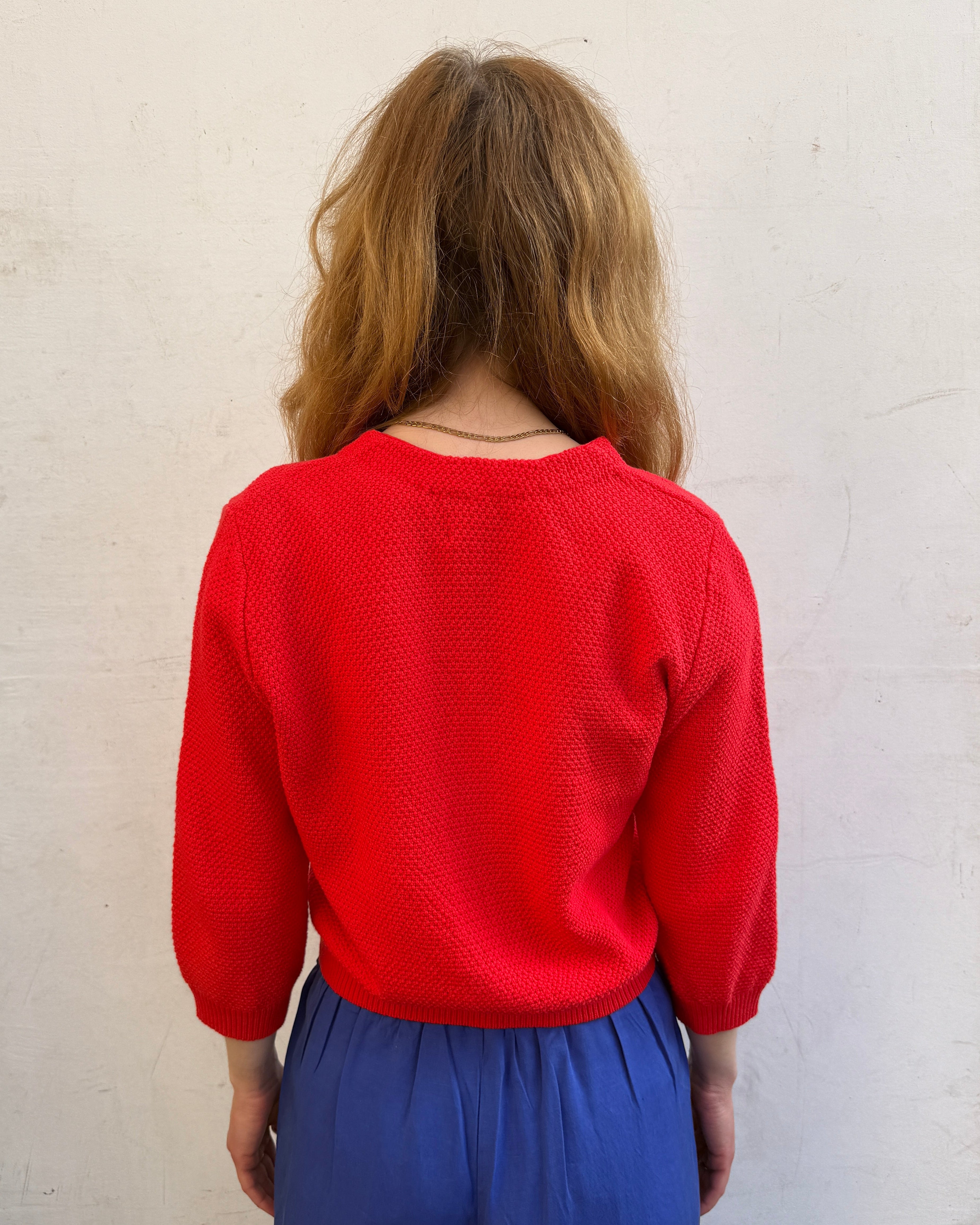 Person wearing a red cardigan