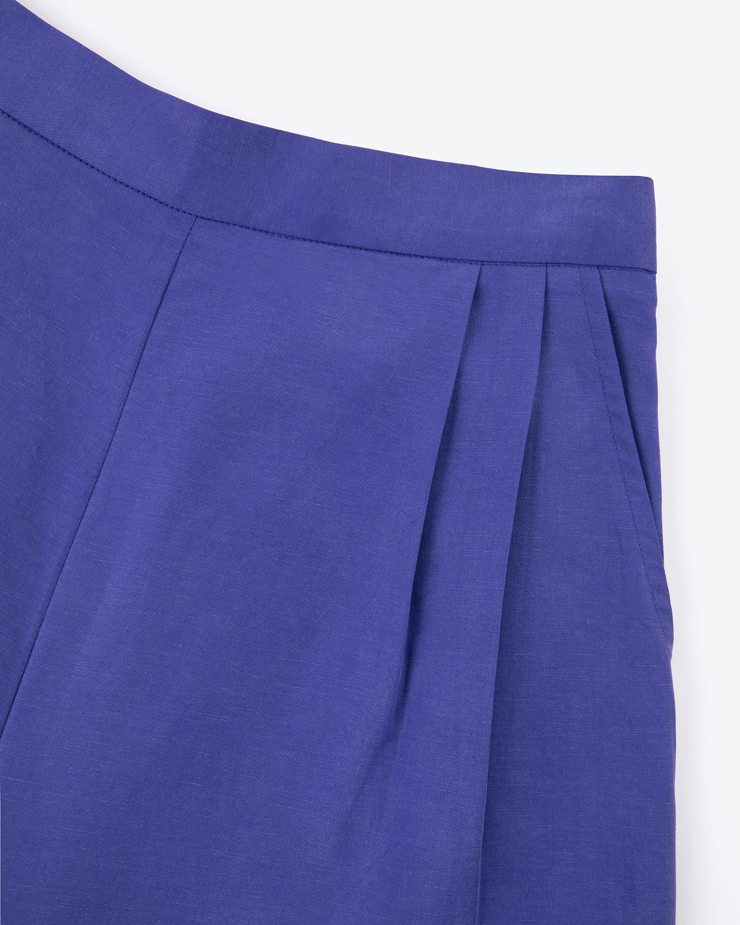 Close-up of a blue pleated fabric on a white background