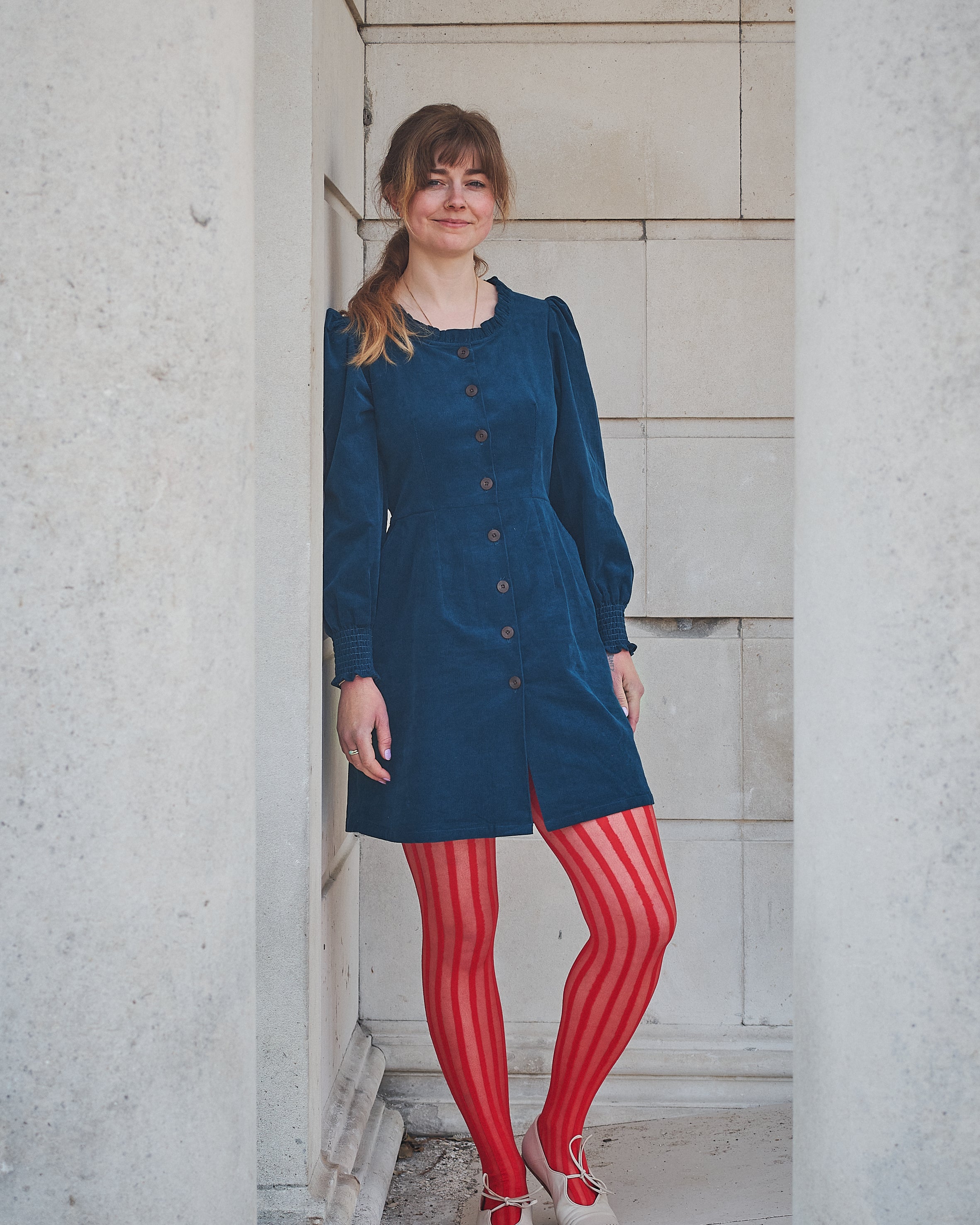 woman in navy corduroy short dress