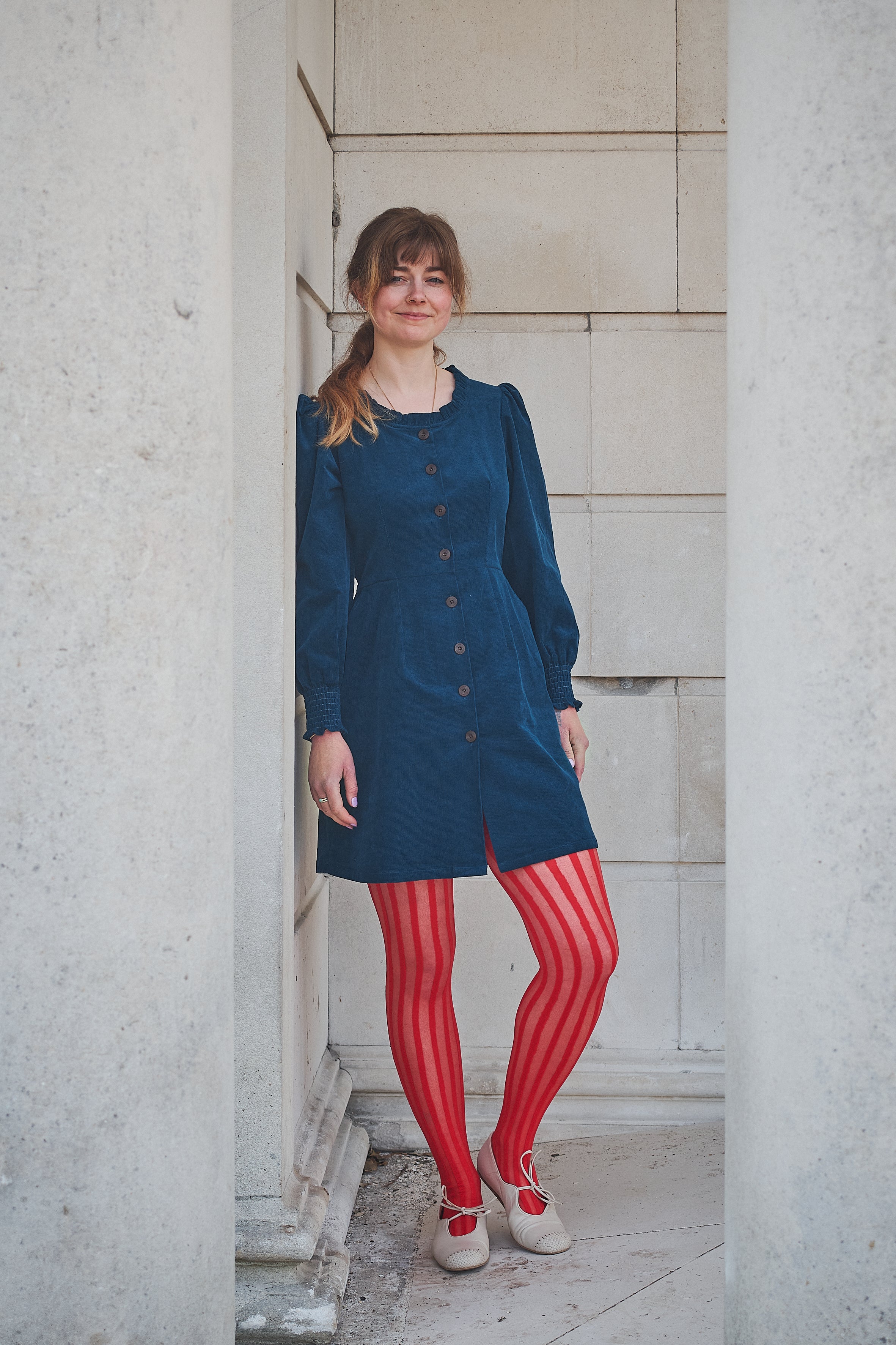 woman in navy corduroy short dress
