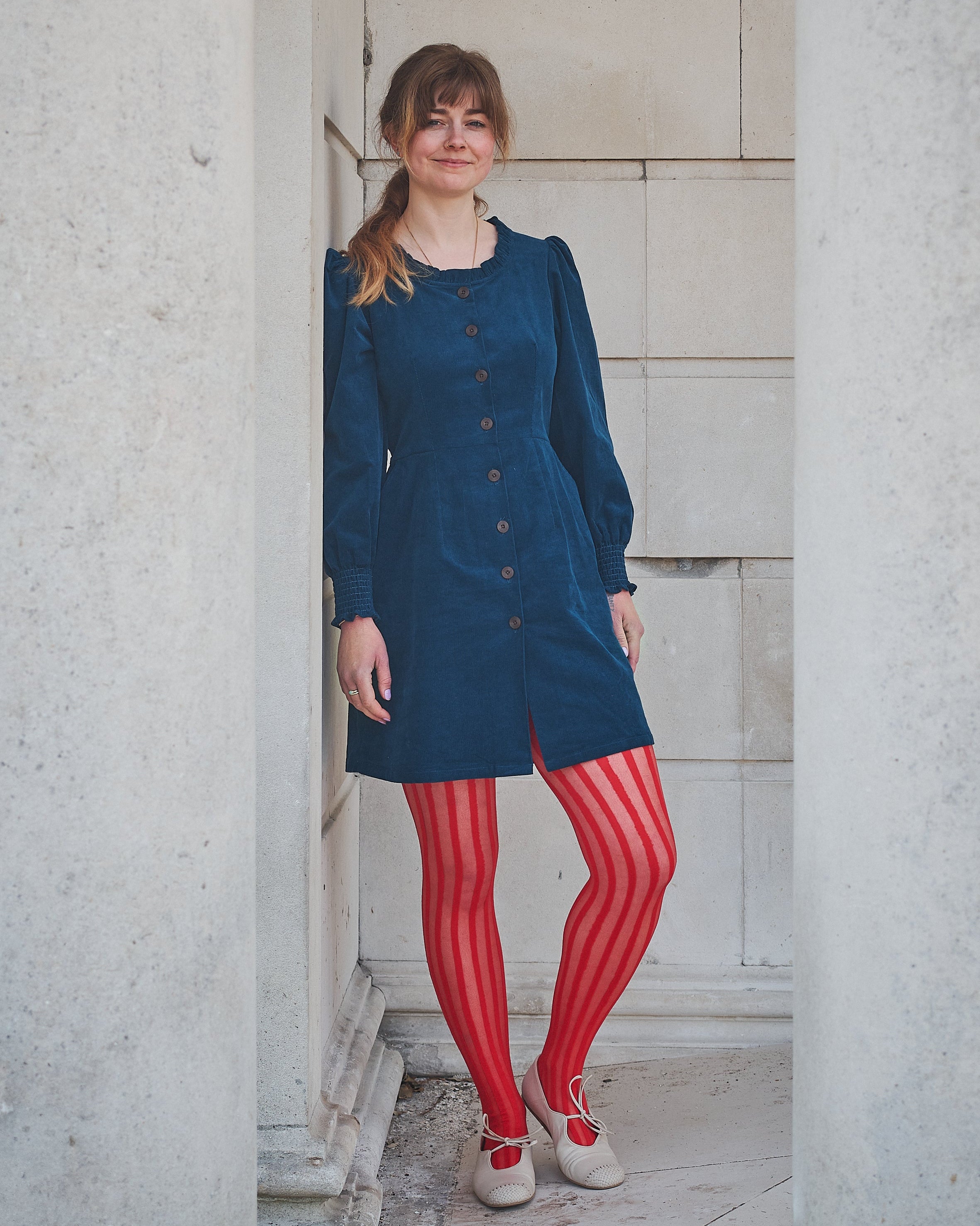 woman in navy corduroy short dress
