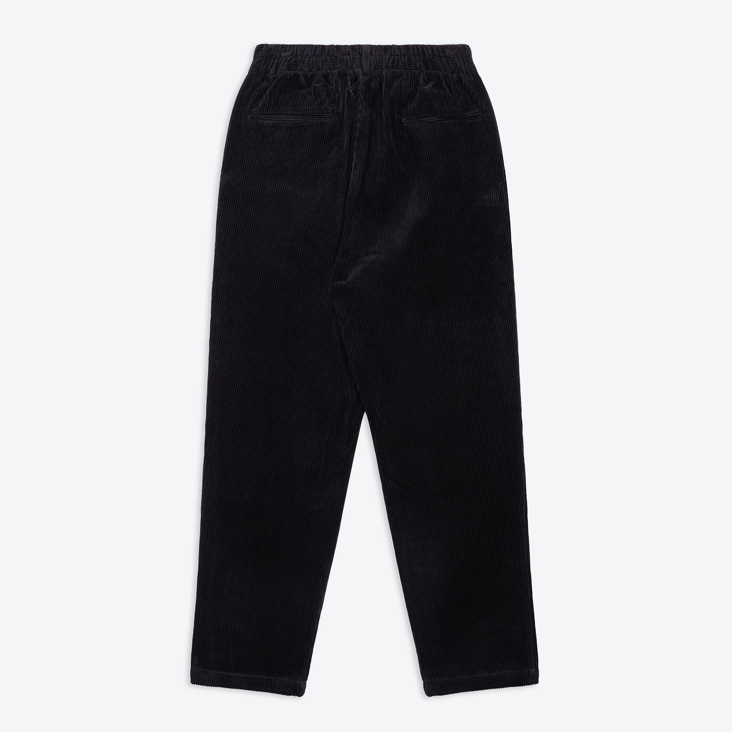 A pair of jet black lowie corduroy easy trouser with a 4-pocket design, belt loops, and pleats.