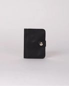 A small black leather card holder or wallet with a snap button closure, standing upright on a light gray background.