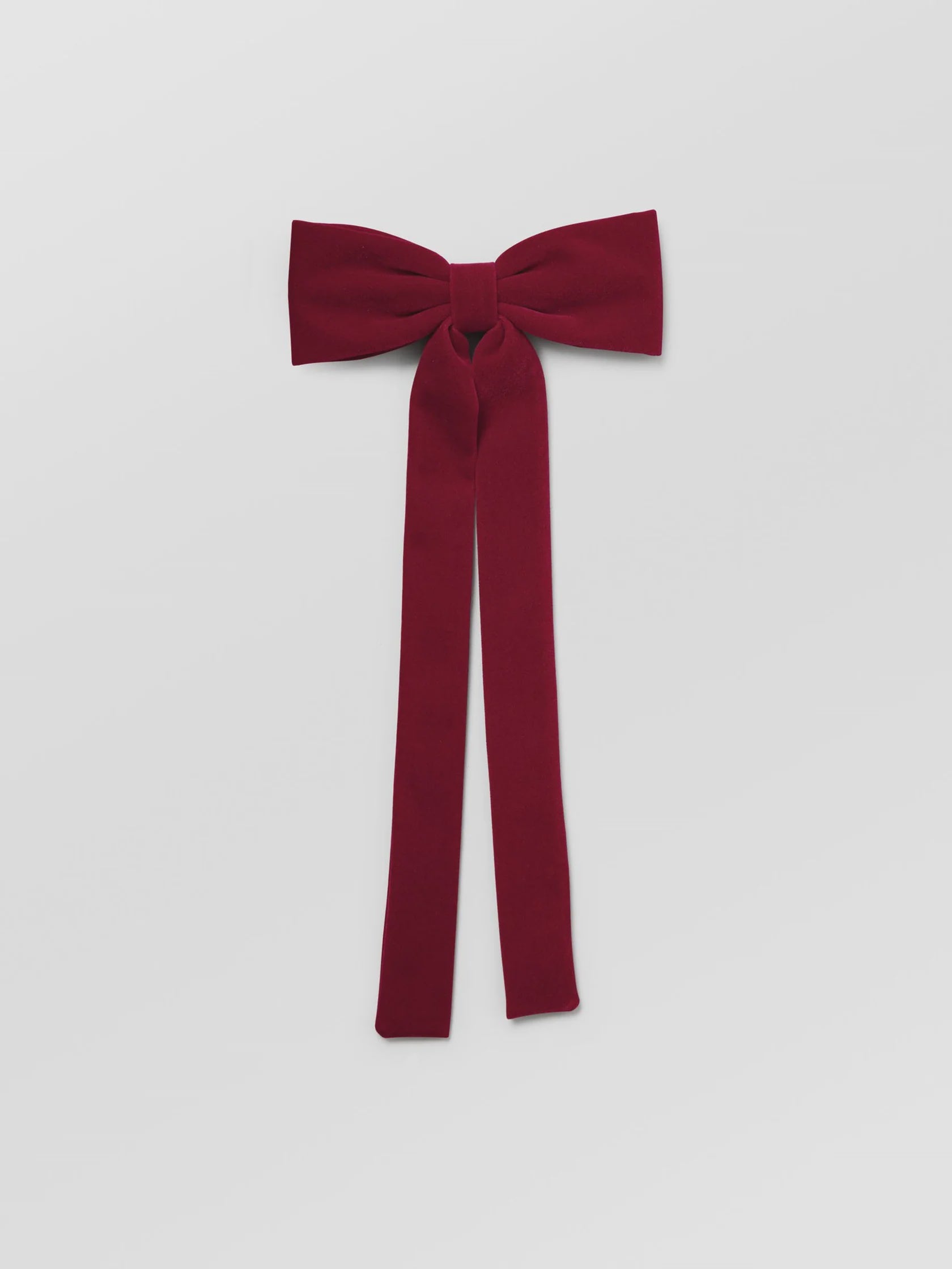 Red bow tie on a light gray background