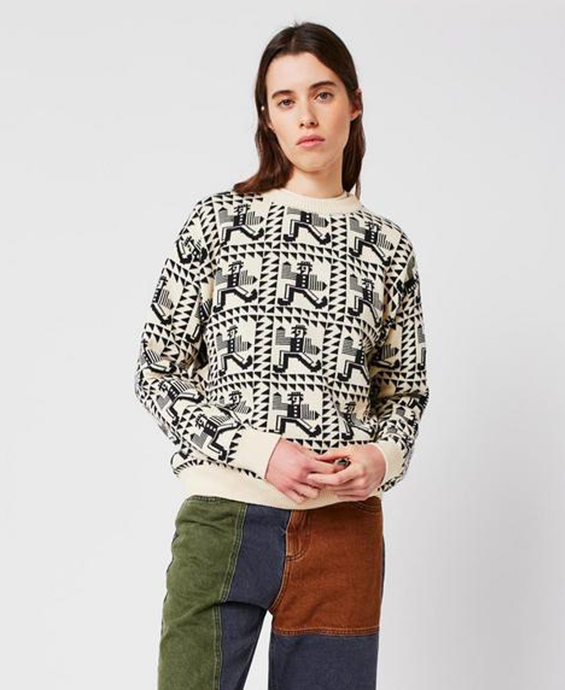 Person wearing a patterned sweater with a plain background