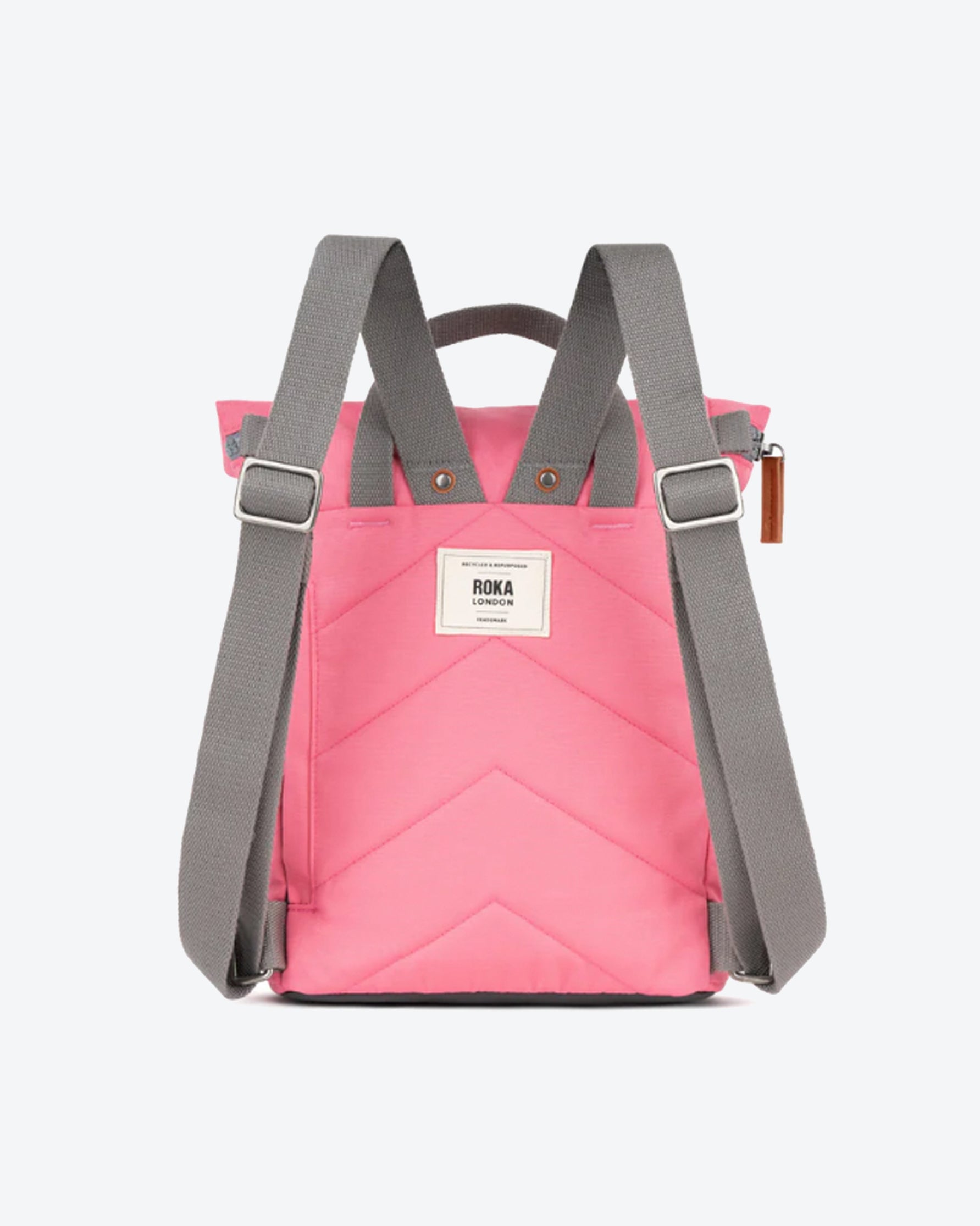Pink backpack with gray straps on a white background