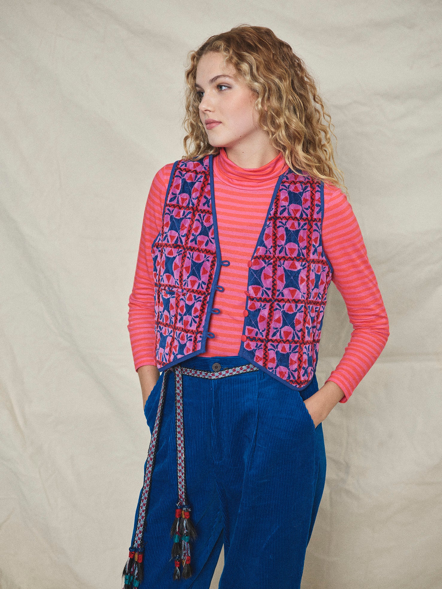 A long-sleeved pink striped organic cotton roll neck t-shirt.