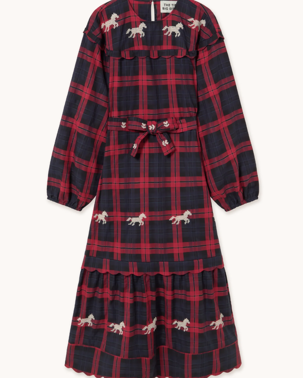 A long-sleeve midi dress with a red and navy blue plaid pattern, decorated with small embroidered white horses, featuring a matching fabric tie belt at the waist.