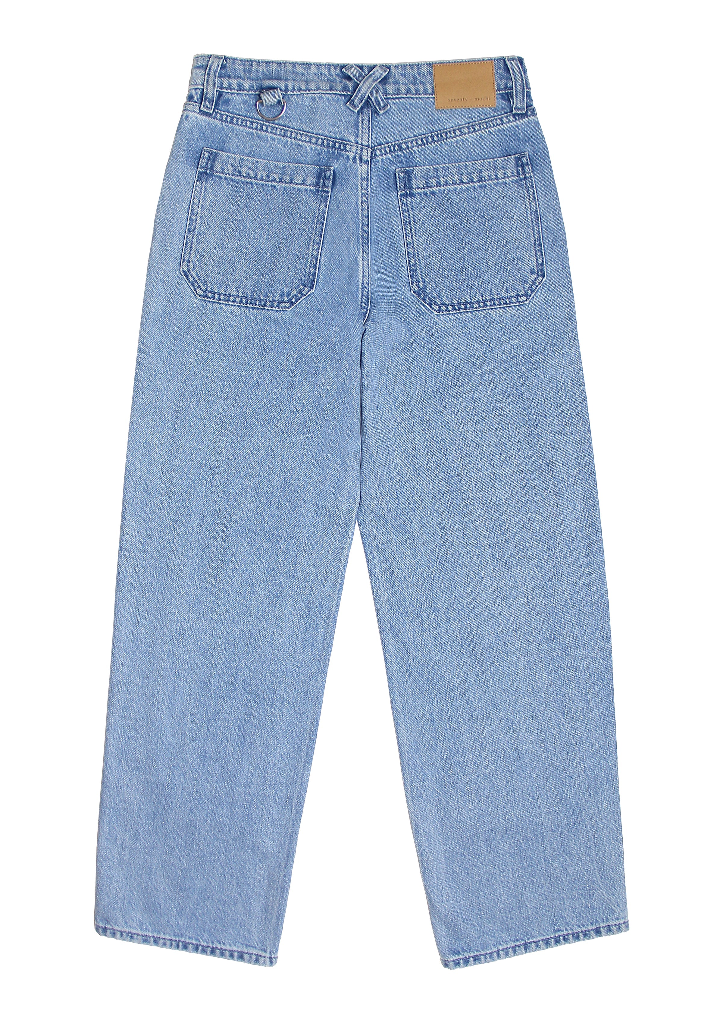 A pair of blue carpenter style jeans with embroidery on the front legs and a center front seam, displayed against a white background.