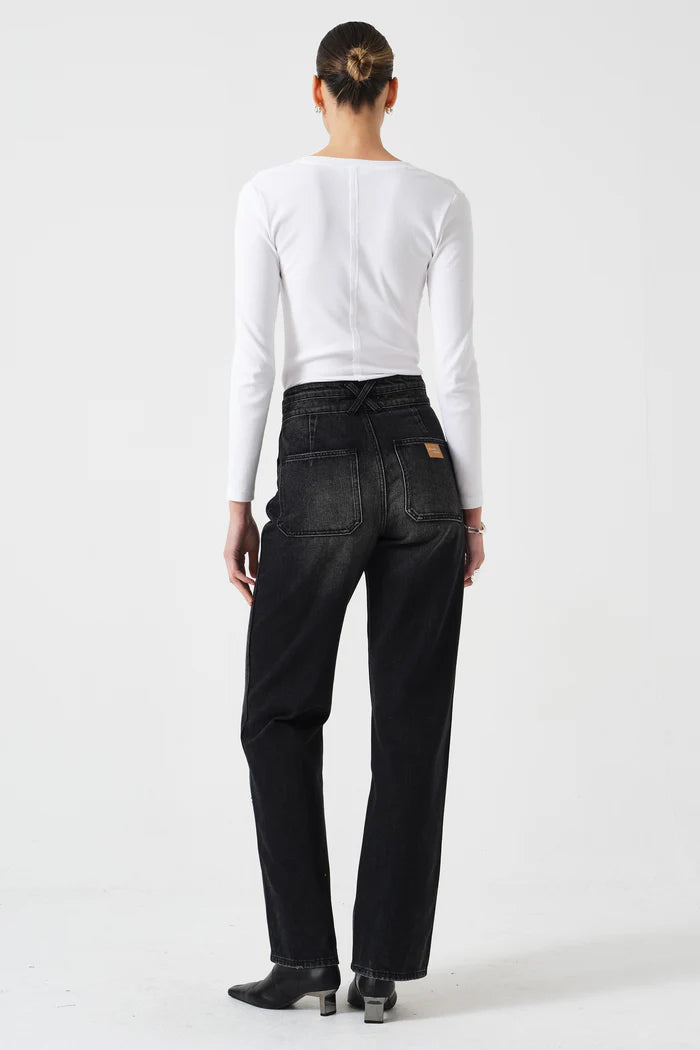 Person wearing black pants and a white long-sleeve shirt on a white background