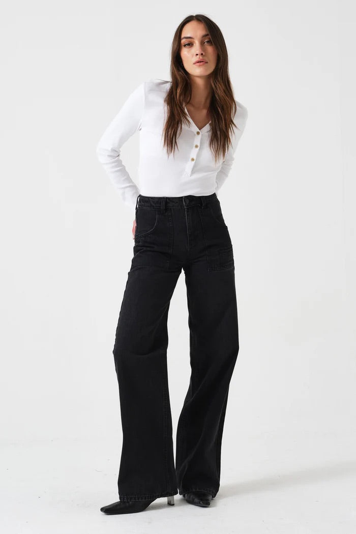 Woman wearing a white blouse and black pants on a white background