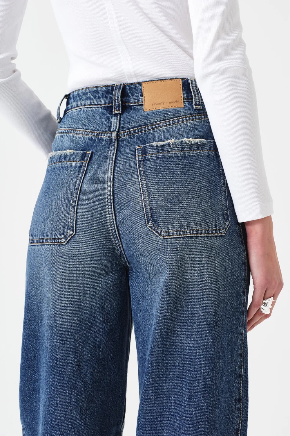 Blue jeans with a white shirt on a white background